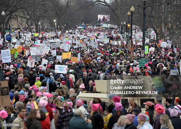 Demonstrators protest on the National Mall in Washington, DC, for the Women's March on January 21, 2017. Hundreds of thousands of protesters...