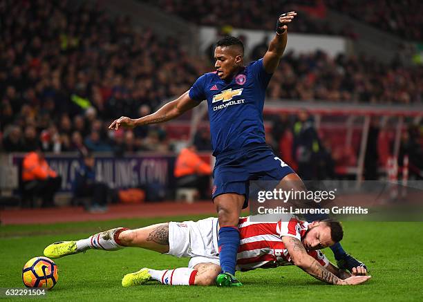 Marko Arnautovic of Stoke City tackles Antonio Valencia of Manchester United during the Premier League match between Stoke City and Manchester United...