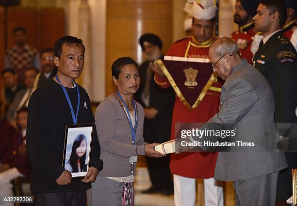 President Pranab Mukherjee presenting the National Awards for Bravery to relative of H. Lalhriatpuii at Rastrapati Bhawan, on January 21, 2017 in New...