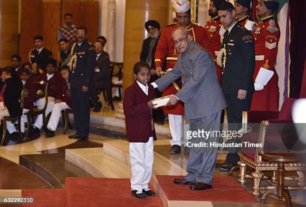 President Pranab Mukherjee presenting the National Awards for Bravery to Neelam Dhruv at Rastrapati Bhawan, on January 21, 2017 in New Delhi, India....