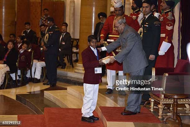 President Pranab Mukherjee presenting the National Awards for Bravery to Sonu Mali at Rastrapati Bhawan, on January 21, 2017 in New Delhi, India. The...