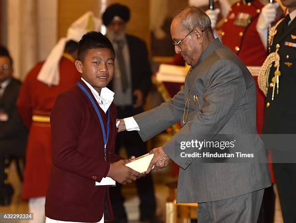 President Pranab Mukherjee presenting the National Awards for Bravery to Thanghilmang Lunkim at Rastrapati Bhawan, on January 21, 2017 in New Delhi,...