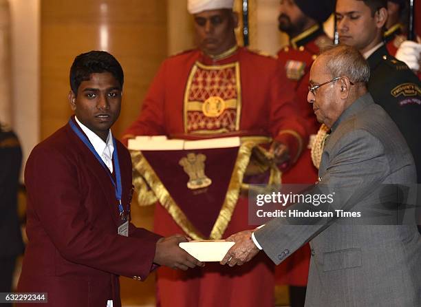 President Pranab Mukherjee presenting the National Awards for Bravery to Binil Manjaly at Rastrapati Bhawan, on January 21, 2017 in New Delhi, India....