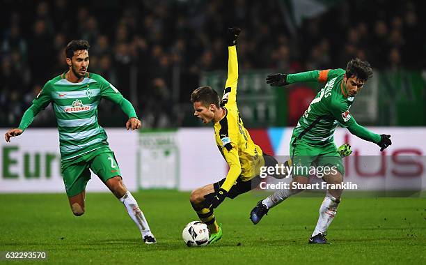 Julian Weigl of Dortmund is challenged by Fin Bartels of Bremen during the Bundesliga match between Werder Bremen and Borussia Dortmund at...