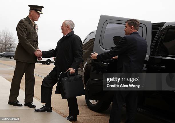 Secretary of Defense James Mattis is greeted by Chairman of the Joint Chiefs of Staff General Joseph Dunford as he arrives for the first day January...