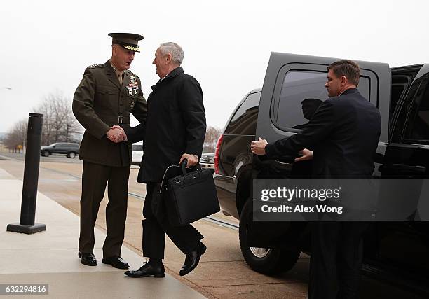 Secretary of Defense James Mattis is greeted by Chairman of the Joint Chiefs of Staff General Joseph Dunford as he arrives for the first day January...