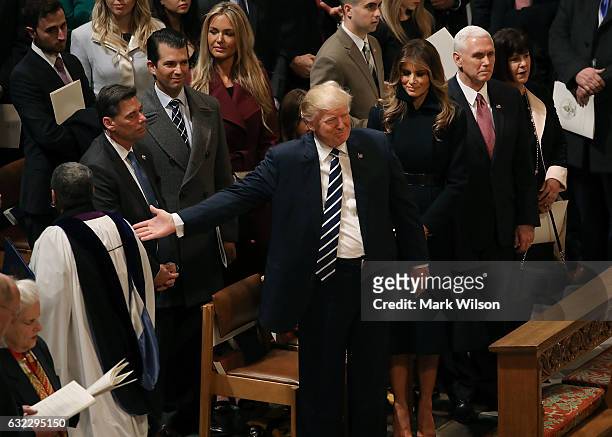 Members of the clergy walk past U.S. President Donald Trump after National Prayer Service concluded at the National Cathedral, on January 21, 2017 in...