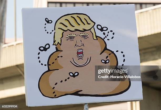 Demonstrators gather to protest against US President Donald Trump in front of the US Embassy on January 21, 2017 in Lisbon, Portugal. Simultaneous...