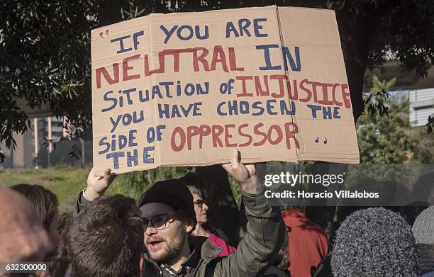 Demonstrators gather to protest against US President Donald Trump in front of the US Embassy on January 21, 2017 in Lisbon, Portugal. Simultaneous...