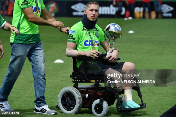 Brazilian Chapecoense goalkeeper Jackson Follmann, a survivor of the LaMia airplane crash in Colombia, holds the Copa Sudamericana trophy at the...