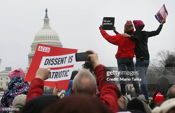 Protesters attend the Women's March on Washington, with the U.S. Capitol seen in the background, on January 21, 2017 in Washington, DC. Large crowds...