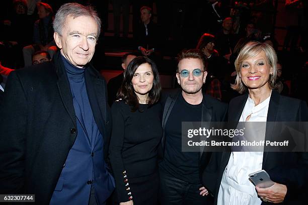 Singer Bono and his wife Ali Hewson standing between Owner of LVMH Luxury Group Bernard Arnault and his wife Helene Arnault attend the Dior Homme...