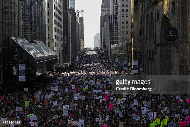 Demonstrators hold signs and march towards Trump Tower during the Women's March in New York, U.S., on Saturday, Jan. 21, 2017. Hundreds of...