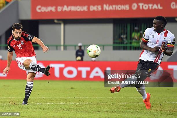 Egypt's forward Abdallah Said kicks the ball past Uganda's midfielder Khalid Aucho during the 2017 Africa Cup of Nations group D football match...