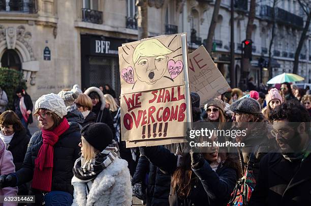 Demonstrator carries a sign during a rally in solidarity with supporters of the Women's March in Washington and many other cities on January 21, 2017...