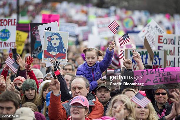 Demonstrators wave flags and hold signs during the Boston Women's March in Boston, Massachusetts, U.S., on Saturday, Jan. 21, 2017. Hundreds of...