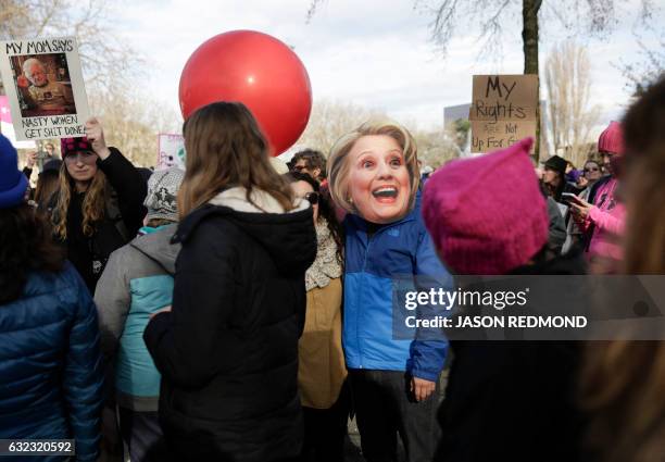 Daniel Riojas of Seattle wears a Hillary Clinton mask as an estimated 120,000 people participate in the Women's March in Seattle, Washington on...