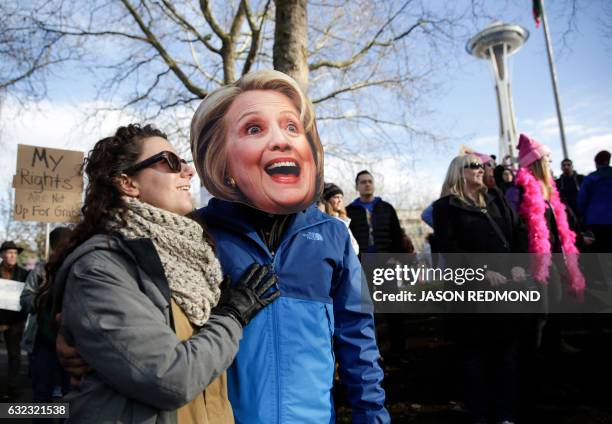 Brittany Martin and her boyfriend Daniel Riojas, pictured in a Hillary Clinton mask, participate in the Women's March in Seattle, Washington on...