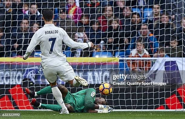 Cristiano Ronaldo of Real Madrid competes for the ball with Carlos Kameni of Malaga during the La Liga match between Real Madrid CF and Malaga CF at...