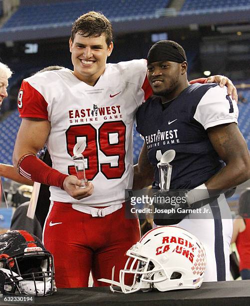 East's Trey Hendrickson of Florida Atlantic and West's Eli McGuire of Louisiana-Lafayette pose as most valuable players of the East-West Shrine Game...