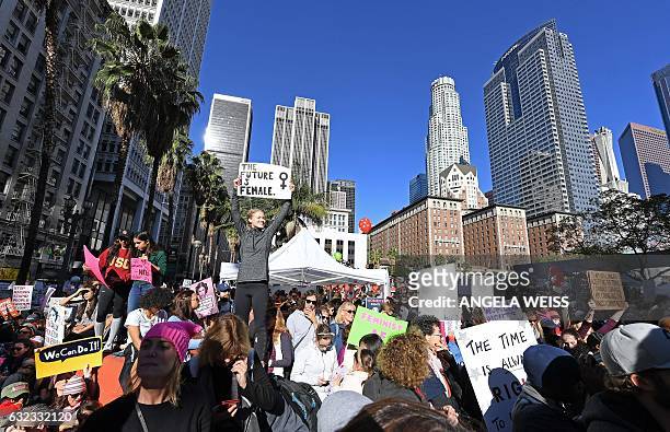Protesters march in Los Angeles during the Women's March on January 21, 2017. Tens of thousands of people took to the streets of London, Paris and...