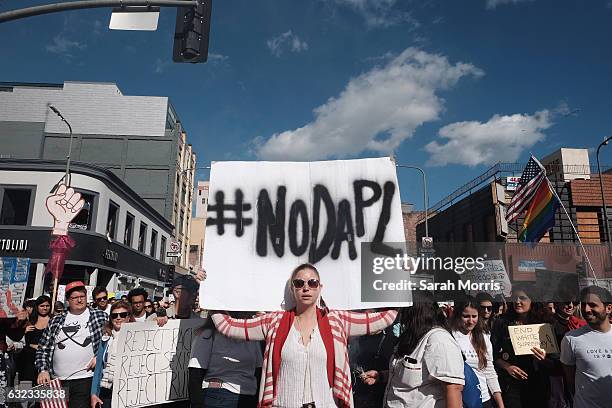 Marchers hold signs during the Women's March on January 21, 2017 in Los Angeles, California. Tens of thousands of people took to the streets of...