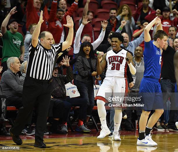 Jovan Mooring of the UNLV Rebels and Jacob Van of the Air Force Falcons react after Mooring hit a 3-pointer with no time left in regulation to tie...