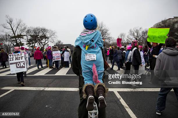 Child wears an unicorn costume as she joins other demonstrator marching along a road during the Women's March on Washington in Washington, D.C.,...