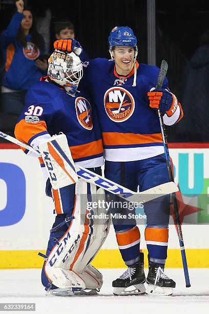 Jean-Francois Berube and Anders Lee of the New York Islanders celebrate after defeating the Los Angeles Kings 4-2 at the Barclays Center on January...