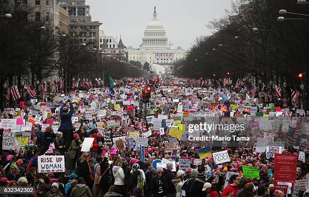 Protesters walk up Pennsylvania Avenue during the Women's March on Washington, with the U.S. Capitol in the background, on January 21, 2017 in...