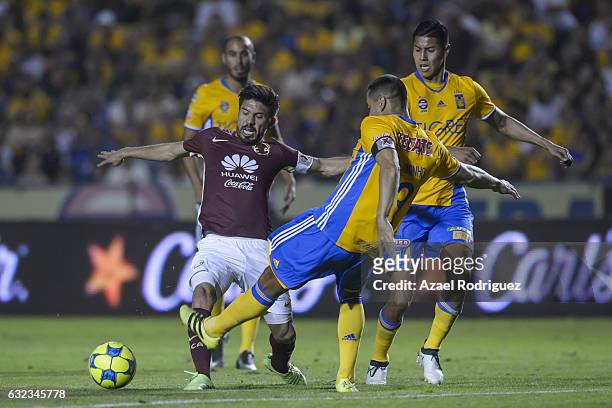 Oribe Peralta of America fights for the ball with Juninho of Tigres during the 3rd round match between Tigres UANL and America as part of the Torneo...