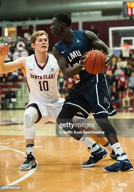 Santa Clara Broncos guard Kai Healy guards Loyola Marymount Lions guard Buay Tuach during the regular season game between Santa Clara Broncos verses...