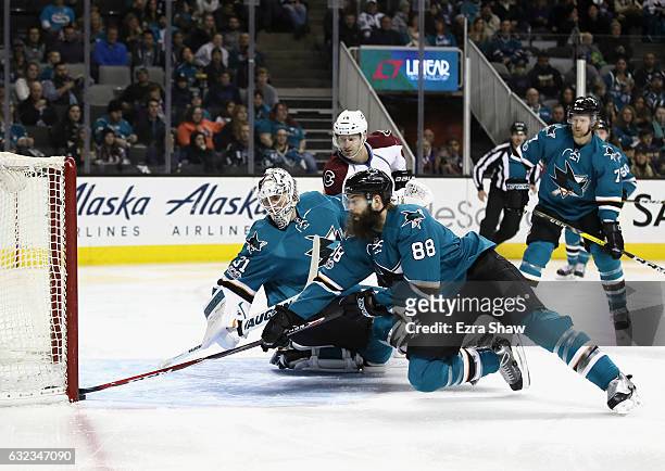 Brent Burns of the San Jose Sharks makes a save on a puck that got past goalie Martin Jones during the first period of their game against the...