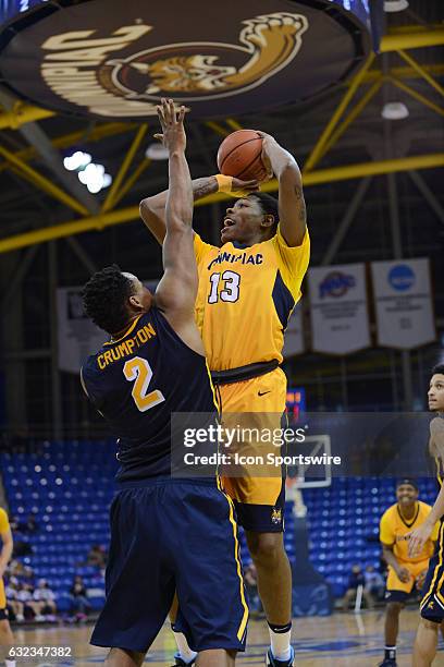 Quinnipiac Bobcats Forward Chaise Daniels shoots in the post while Canisius Golden Griffins Forward Jermaine Crumpton defends as the Canisius Golden...