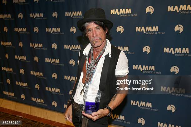 Musician Joe Perry poses backstage with the Les Paul Award at the TEC Awards during NAMM Show 2017 at the Anaheim Hilton on January 21, 2017 in...