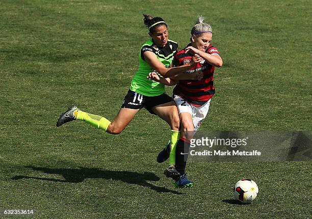 Ashleigh Sykes of Canberra and Caitlin Cooper of the Wanderers compete for the ball during the round 13 W-League match between the Western Sydney...