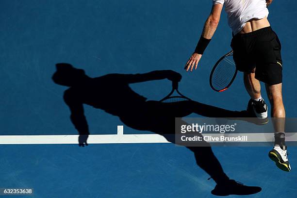 The shadow of Andy Murray of Great Britain is seen as he serves in his fourth round match against Mischa Zverev of Germany on day seven of the 2017...