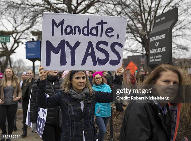 Marcher attending the Women's March on Washington holds up a sign questioning President Donald Trump's mandate on January 21, 2017 in Washington, DC....