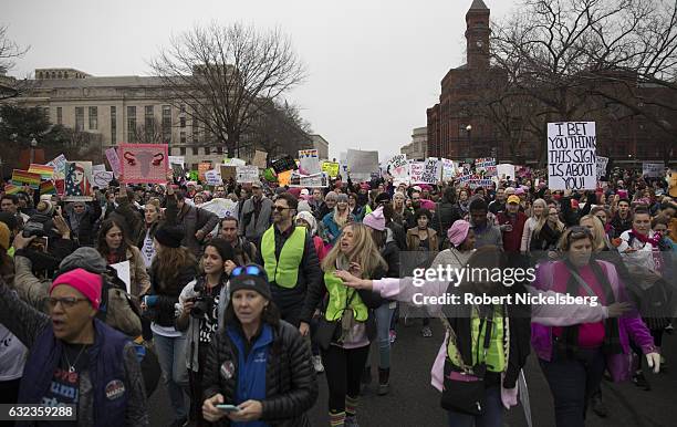 Marchers attending the Women's March on Washington carry signs critical of President Donald Trump on January 21, 2017 in Washington, DC. President...