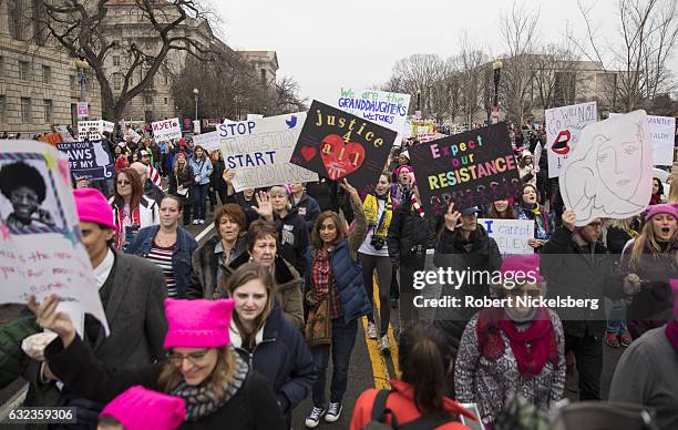 Marchers attending the Women's March on Washington hold up women's rights signs on January 21, 2017 in Washington, DC. President Donald Trump was...