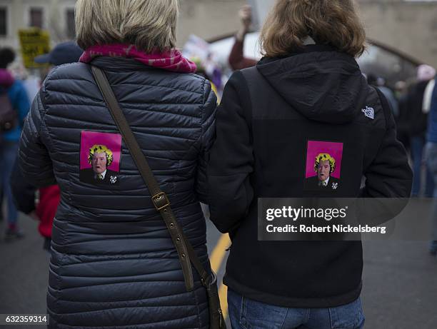 Two marchers attending the Women's March on Washington altered images of President Donald Trump on their jackets on January 21, 2017 in Washington,...