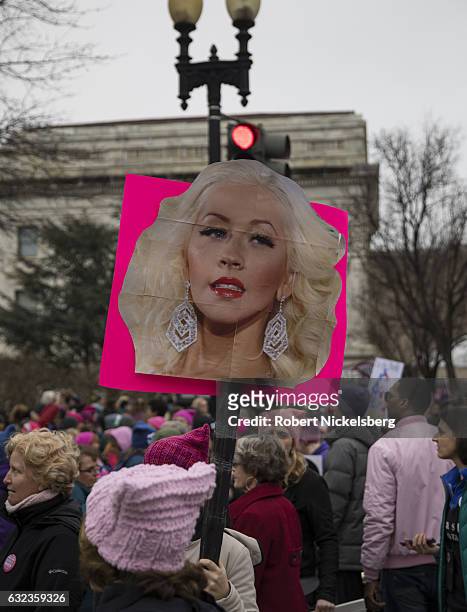 Marcher attending the Women's March on Washington holds up a sign with a picture of singer and feminist supporter Christina Aguilera on January 21,...