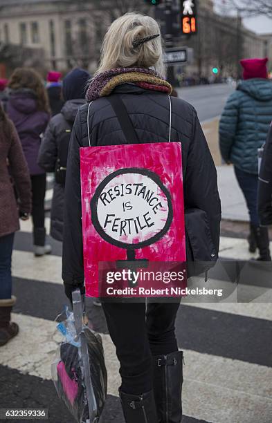 Marcher attending the Women's March on Washington wears a "resistance is fertile" sign on January 21, 2017 in Washington, DC. President Trump was...