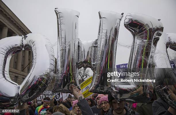 Marchers attending the Women's March on Washington hold up letters for the state of Ohio and women's rights signs on January 21, 2017 in Washington,...