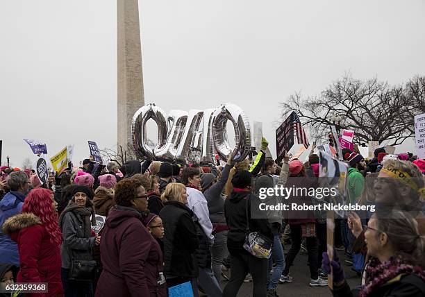 Marchers attending the Women's March on Washington hold up letters for the state of Ohio and women's rights signs on January 21, 2017 in Washington,...