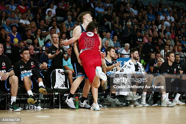 Damian Martin of the Wildcats clashes into Finn Delany and the Breakers' bench after saving a ball in play during the round 16 NBL match between the...