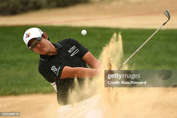 Byeong Hun An of South Korea plays from a bunker on the 8th hole during the final round of the Abu Dhabi HSBC Championship at Abu Dhabi Golf Club on...