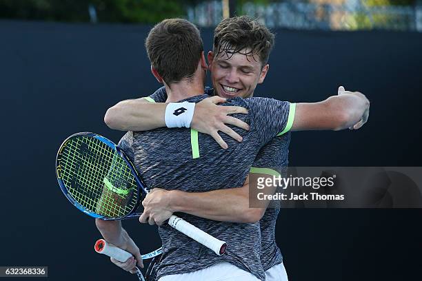 Simon Carr of Ireland and Max Stewart of Great Britain celebrate winning their first round match against Dan Added of France and Matteo Martineau of...
