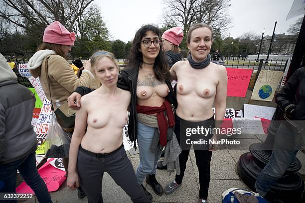 Three bare-chested female stand near the White House in Washington DC, on Jan. 21 during the Womens March on Washington, a day after the inauguration...