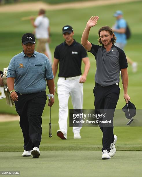 Tommy Fleetwood of England and Kiradech Aphibarnrat of Thailand walk to the 18th green during the final round of the Abu Dhabi HSBC Championship at...
